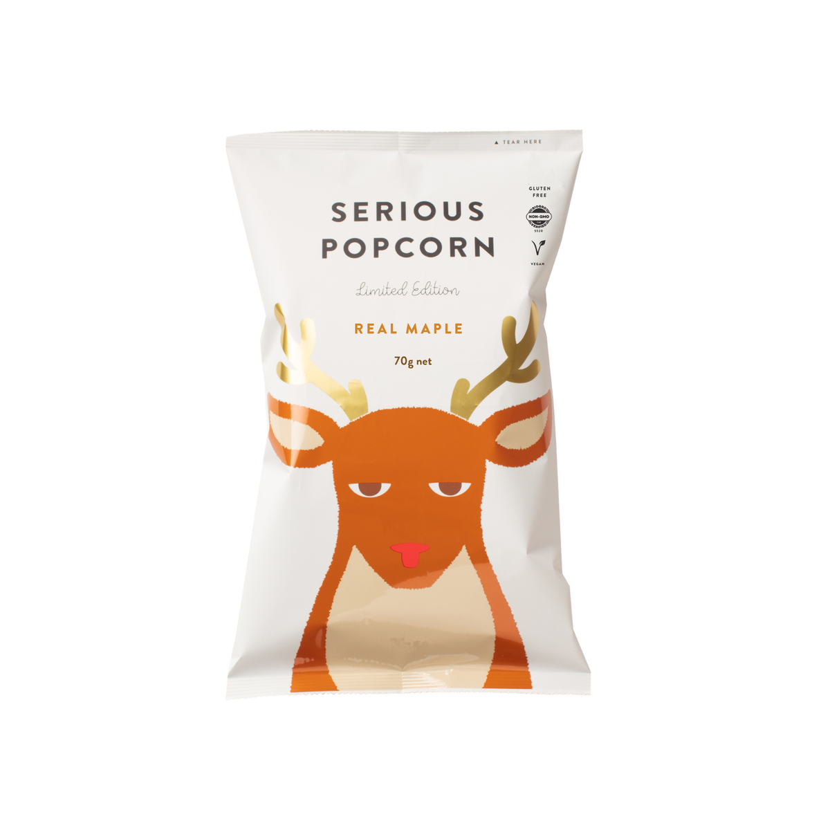 A 70g bag of Serious Popcorn 'Real Maple' Limited Edition popcorn. The packaging is white with a stylized orange and beige cartoon reindeer graphic and black text.